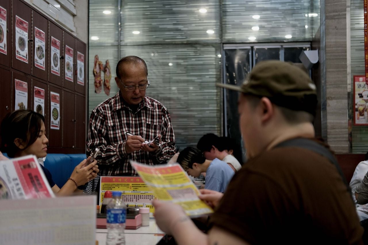 Guests in the dining room of Wong Ming Kee, a restaurant in Hong Kong