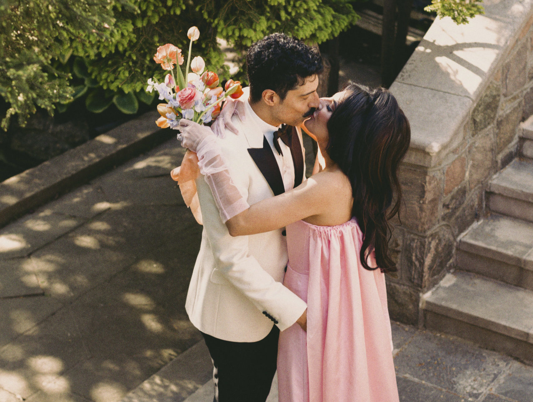 Roya and Mani kissing at Graydon Hall on their wedding day