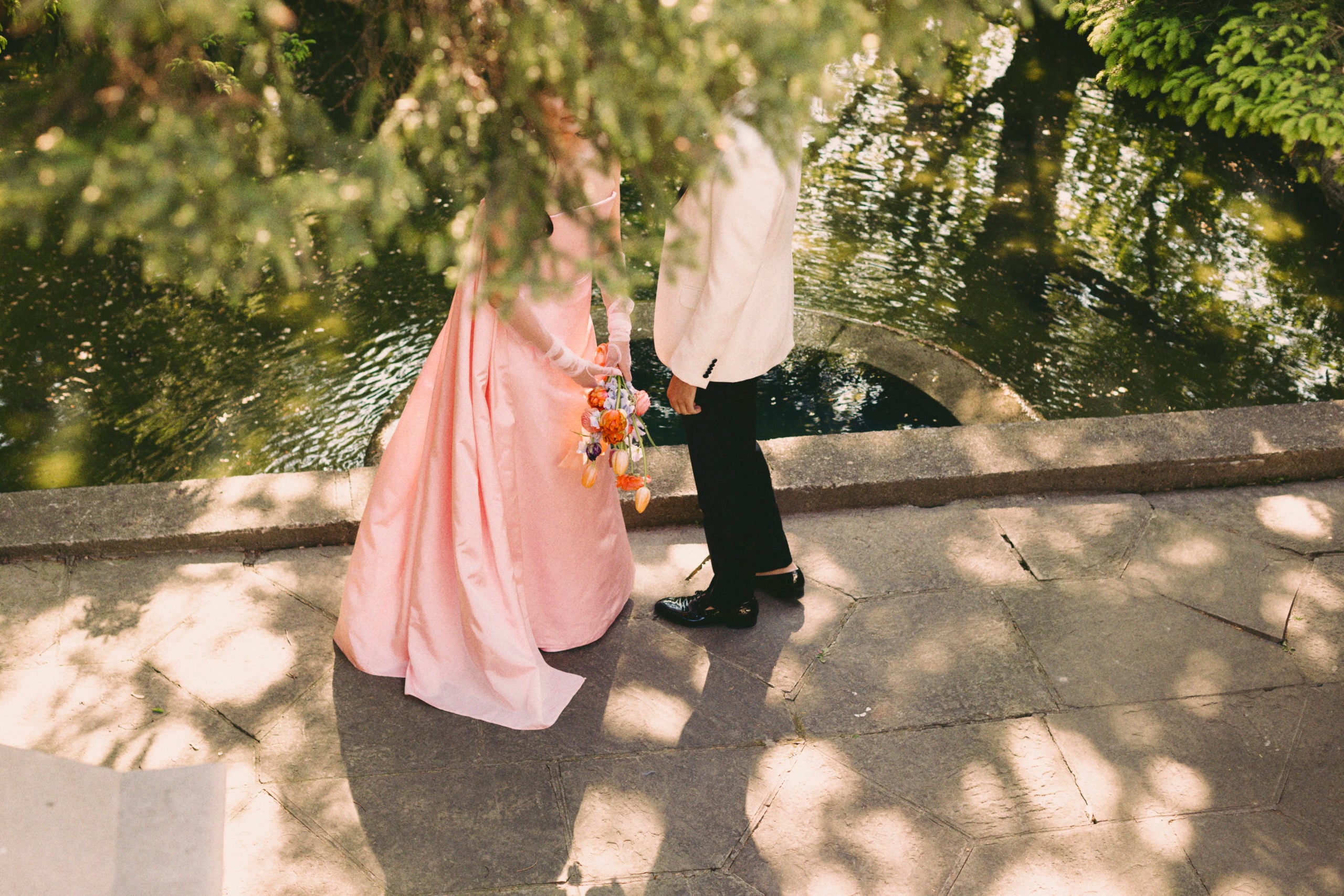 Roya and Mani standing outside at Graydon hall with foliage covering their faces