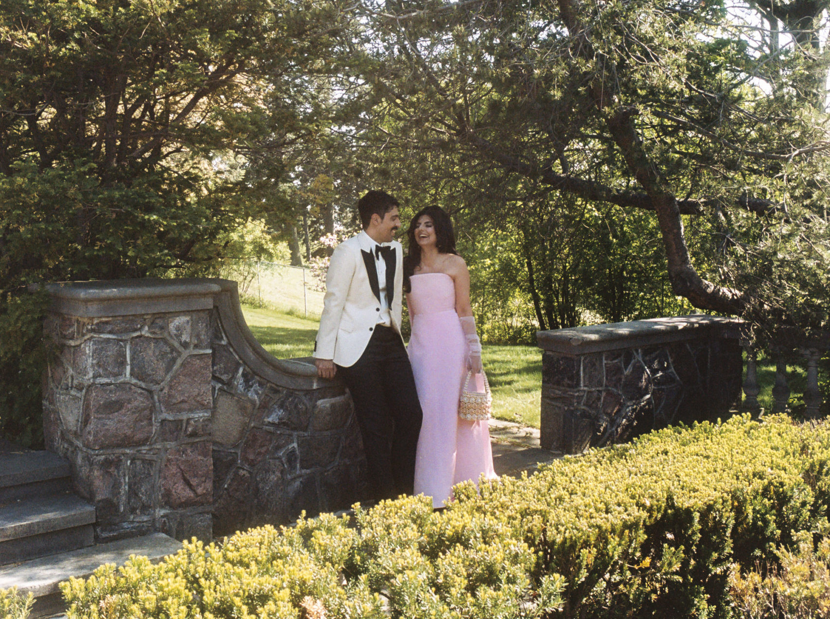 Roya and Mani sitting on a stone wall at Graydon Hall