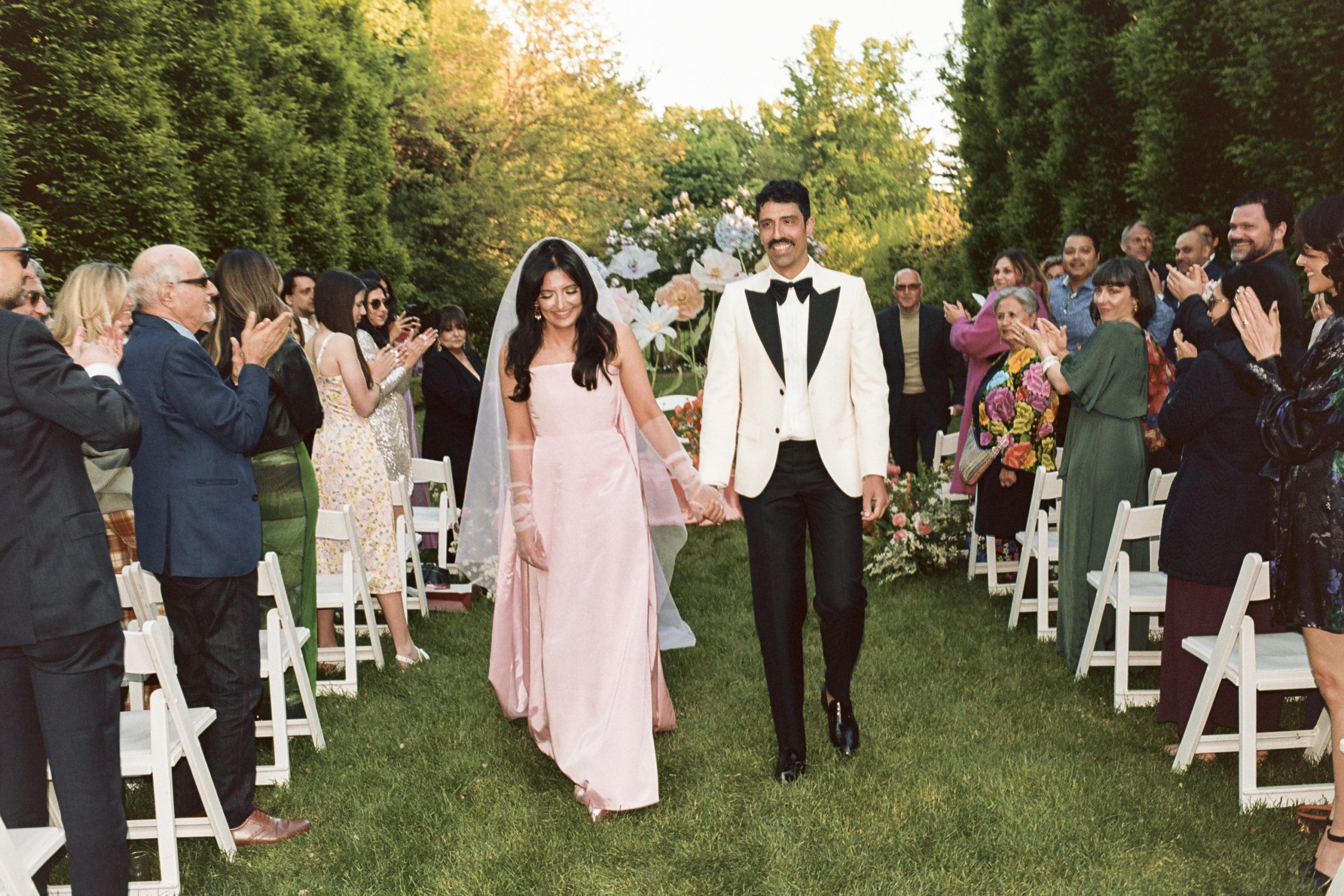 Roya and Mani walking up the aisle on their wedding day