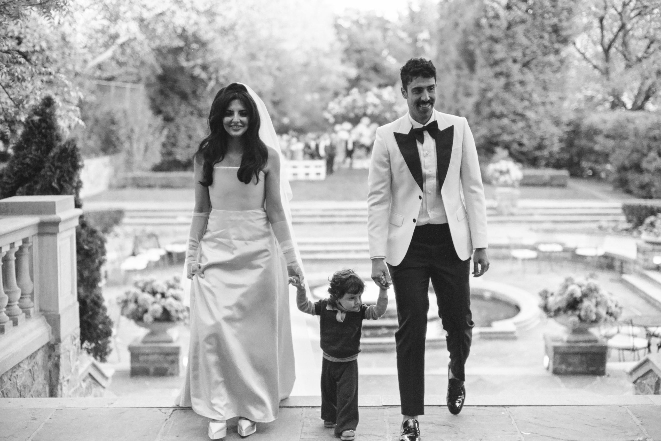 The couple walking with their son, Kasra