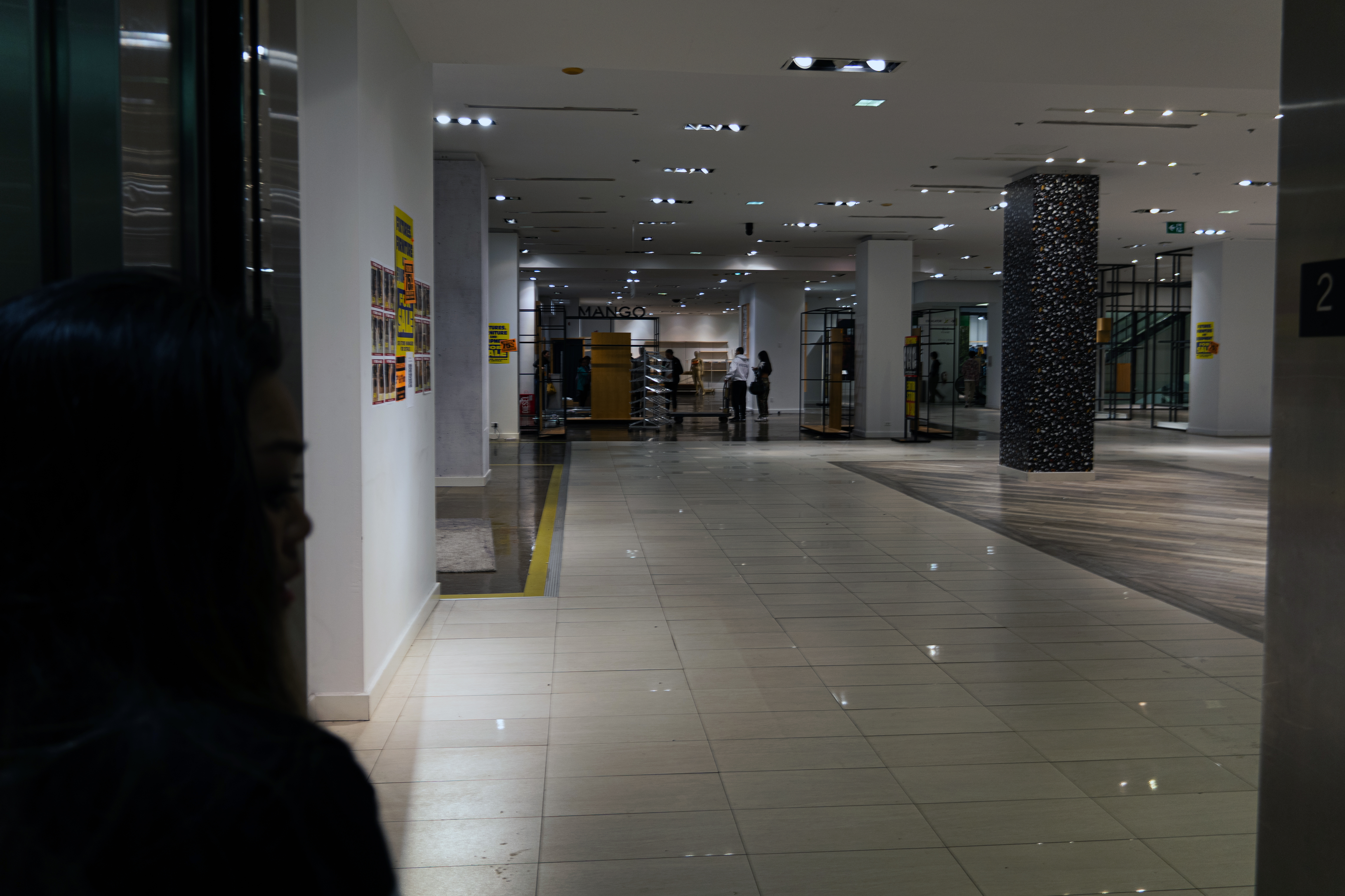 The final few customers move through the Bay's empty store looking for deals. 
