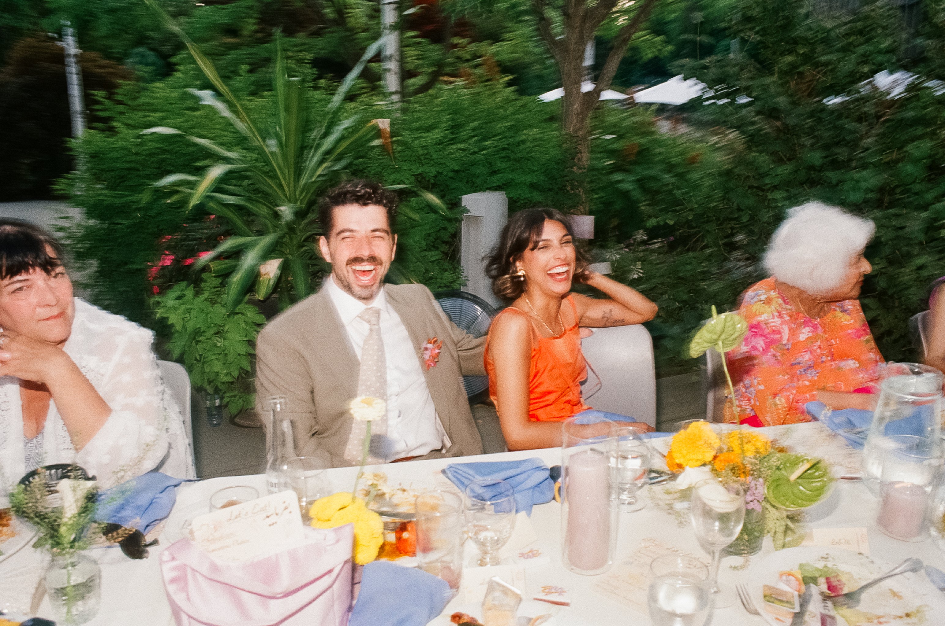 Melina and Zach at a table at their wedding