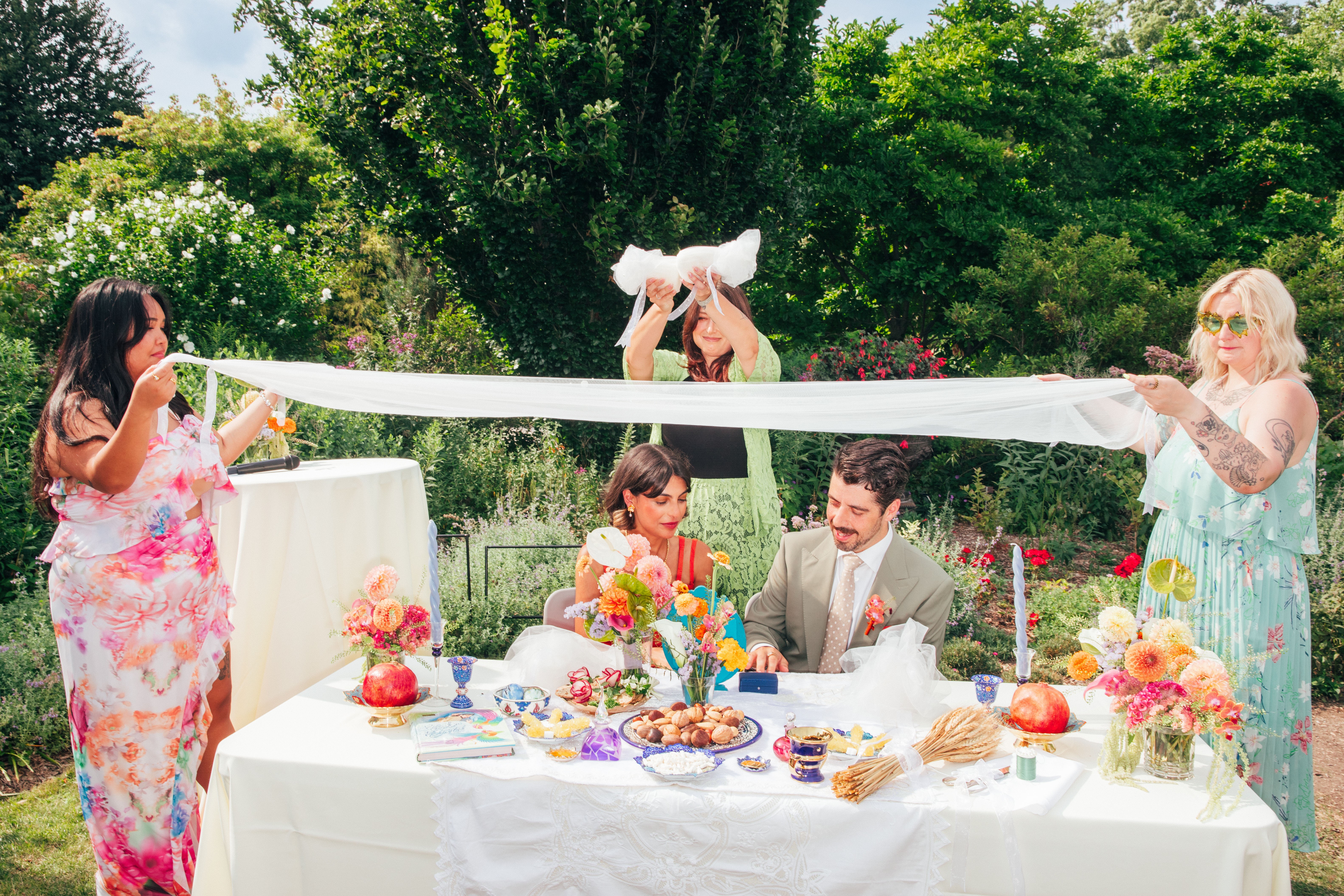 Melina and Zach at a sweetheart table at their wedding at the Toronto Botanical Gardens