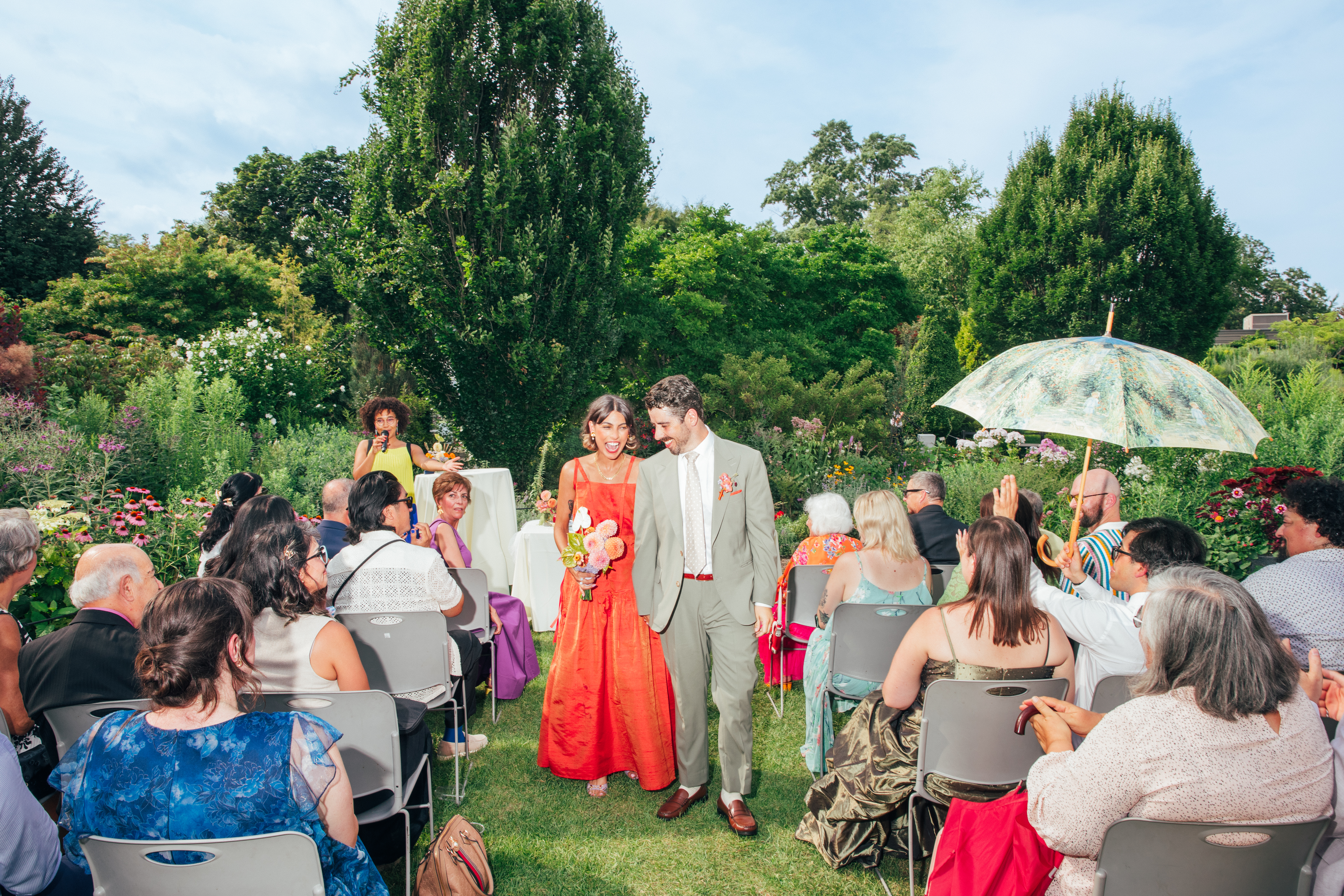 Melina and Zach walking down the aisle at their wedding