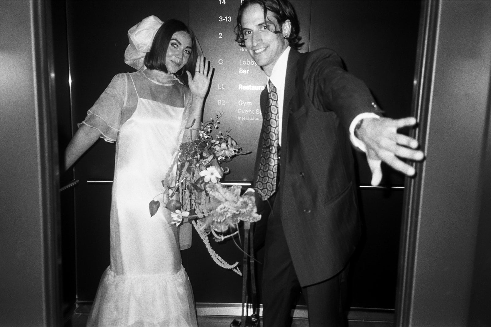 Brjánn and Ryanne pose for a photo in an elevator.