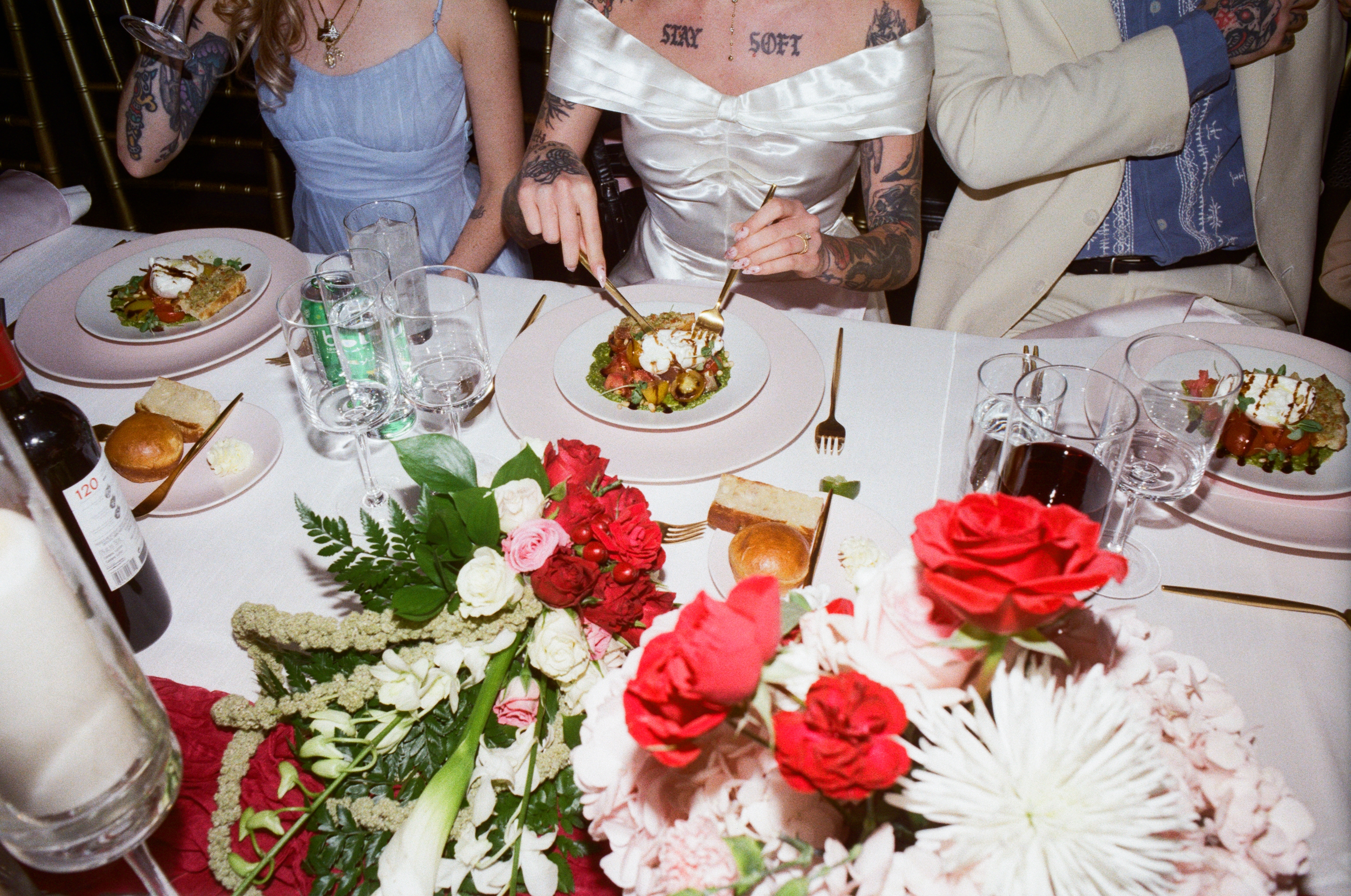 Cassy cuts into a plate of food at the wedding dinner