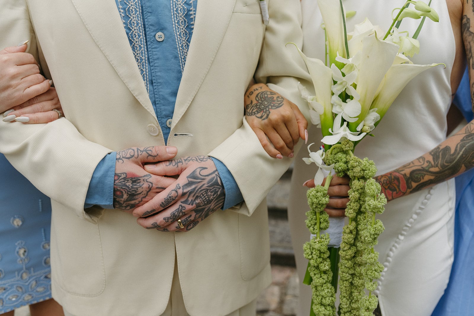 A shot of Cassy and Larry arm in arm, with Cassy holding a floral arrangement