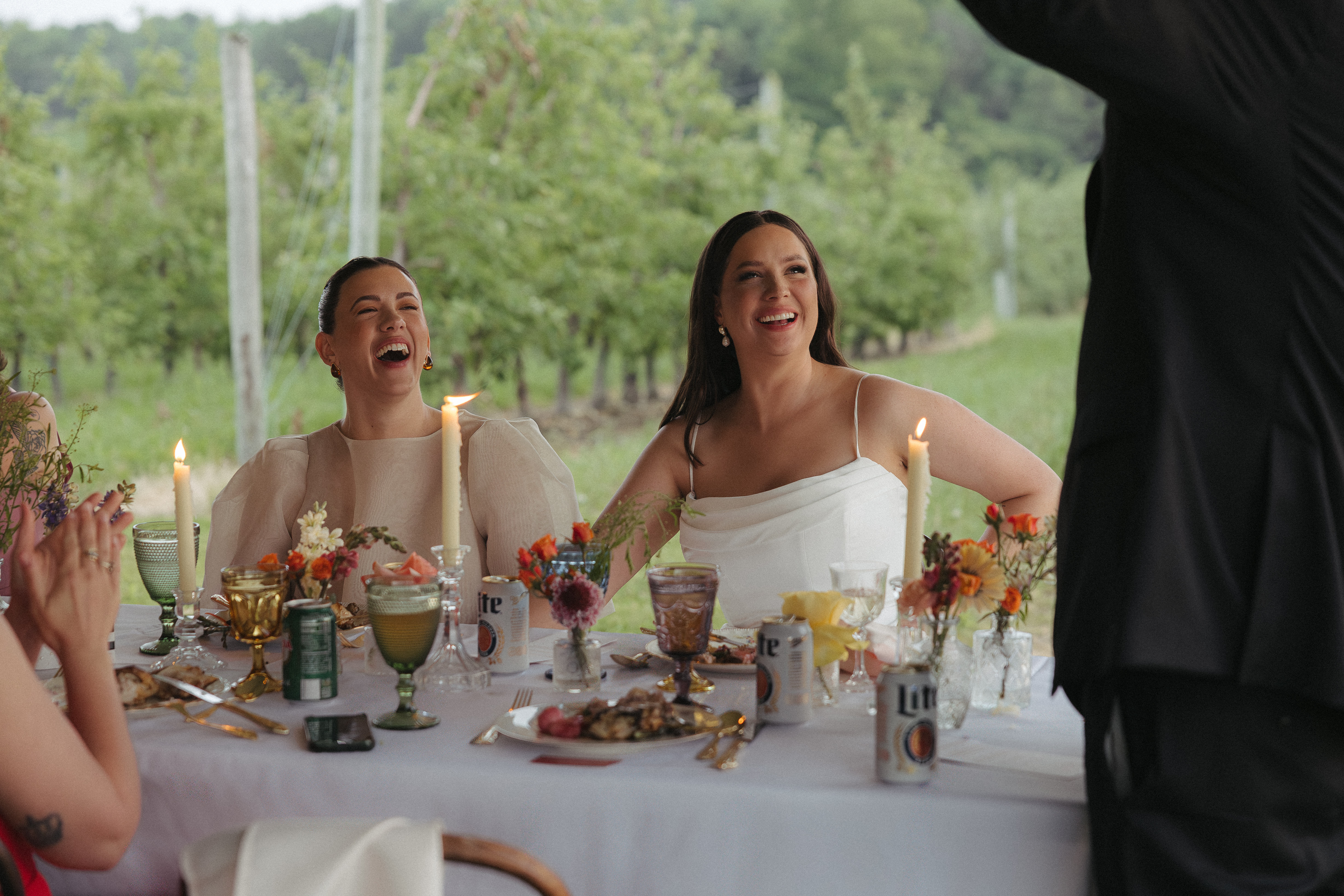 Two brides seated at dinner.