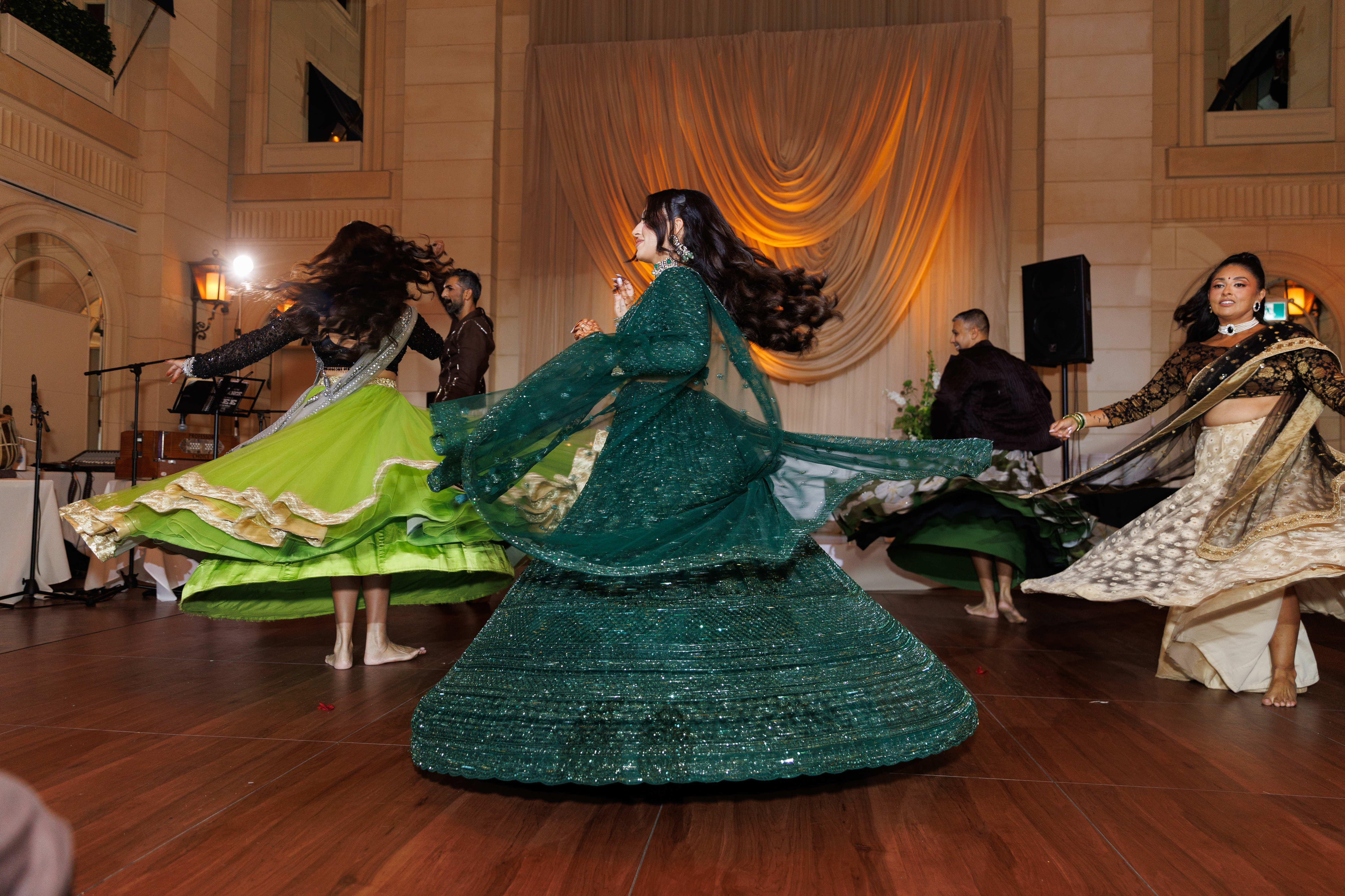 Gital and four other dancers spin as they perform a dance.