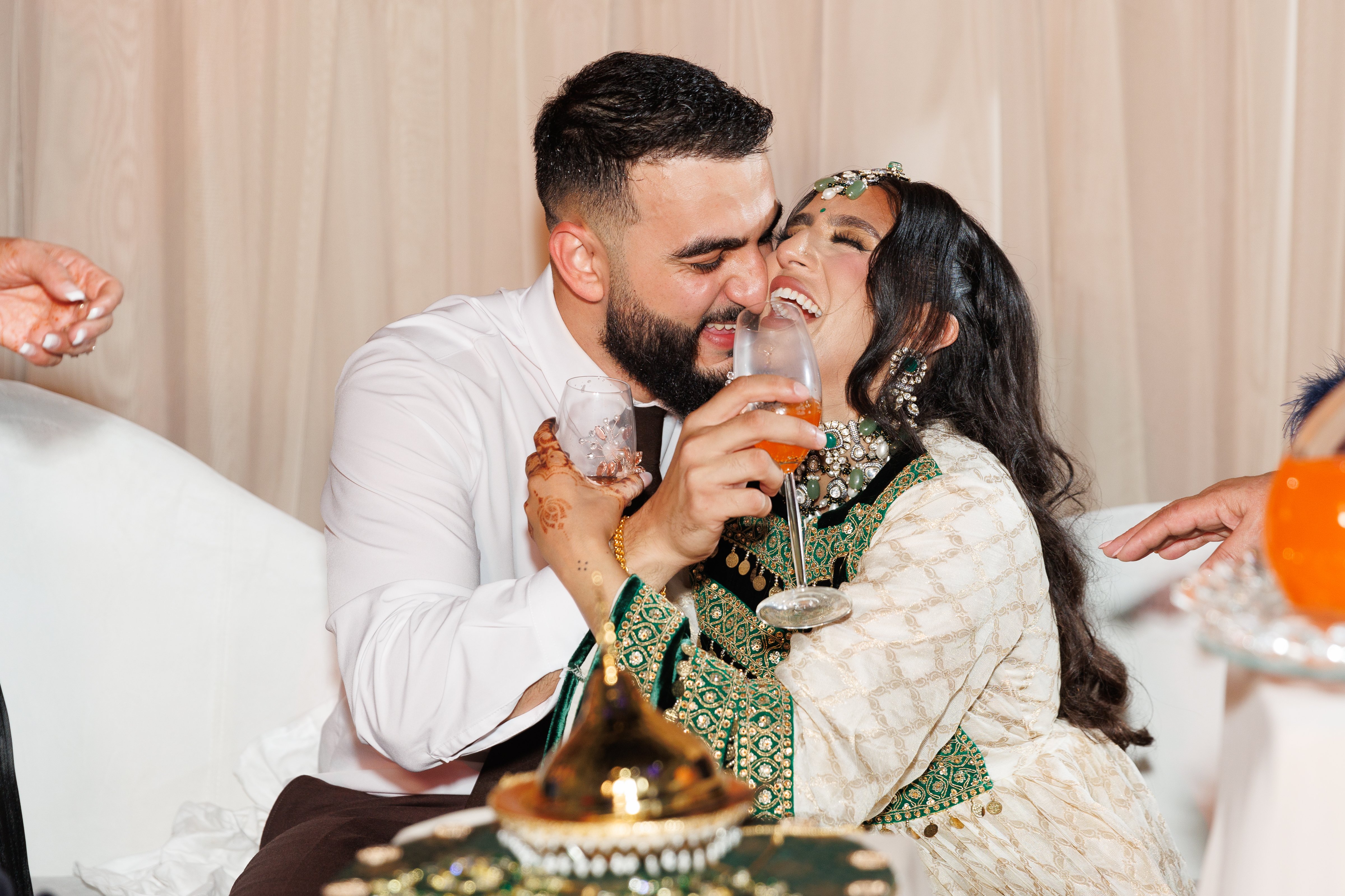 Harris kisses Gital on the wedding dias at the Windsor Arms Hotel. Both are laughing.
