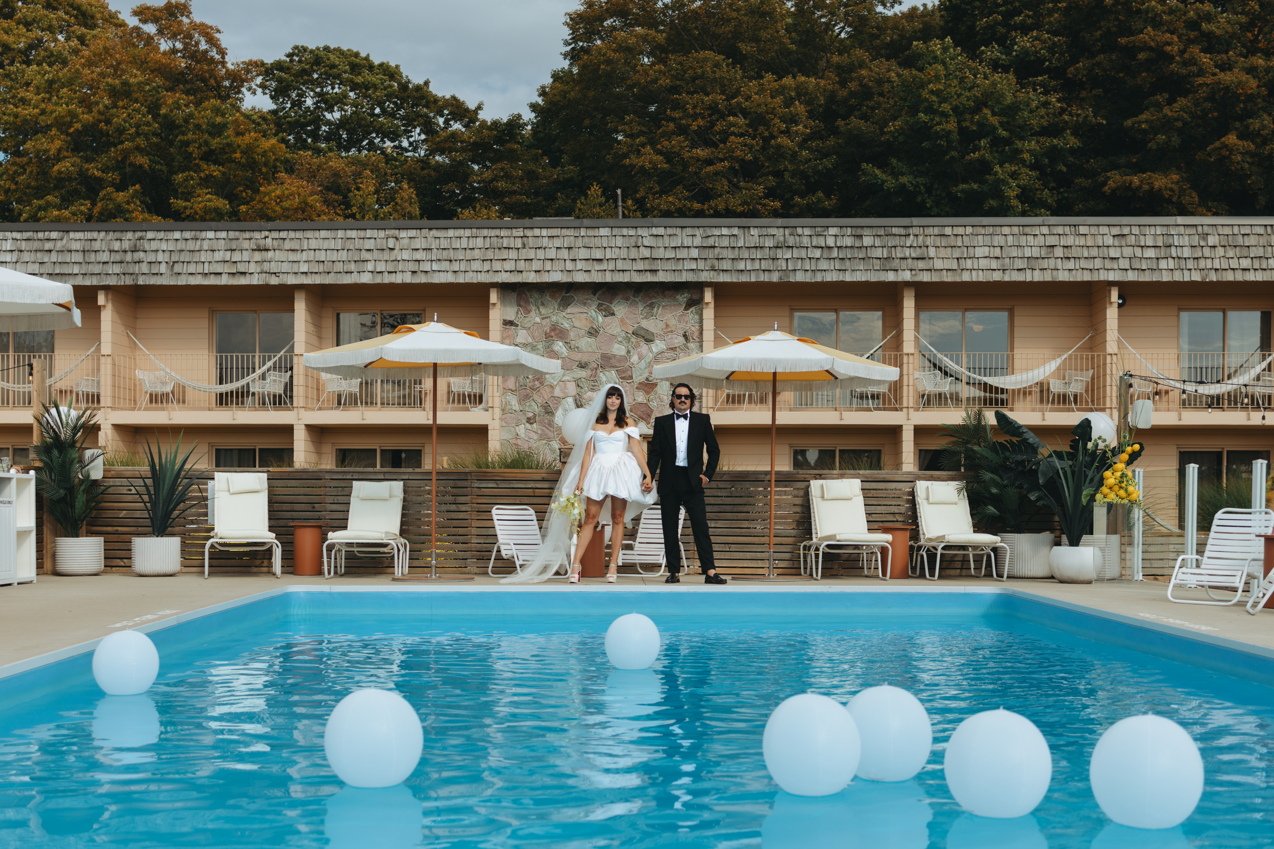 Bride and groom in front of pool