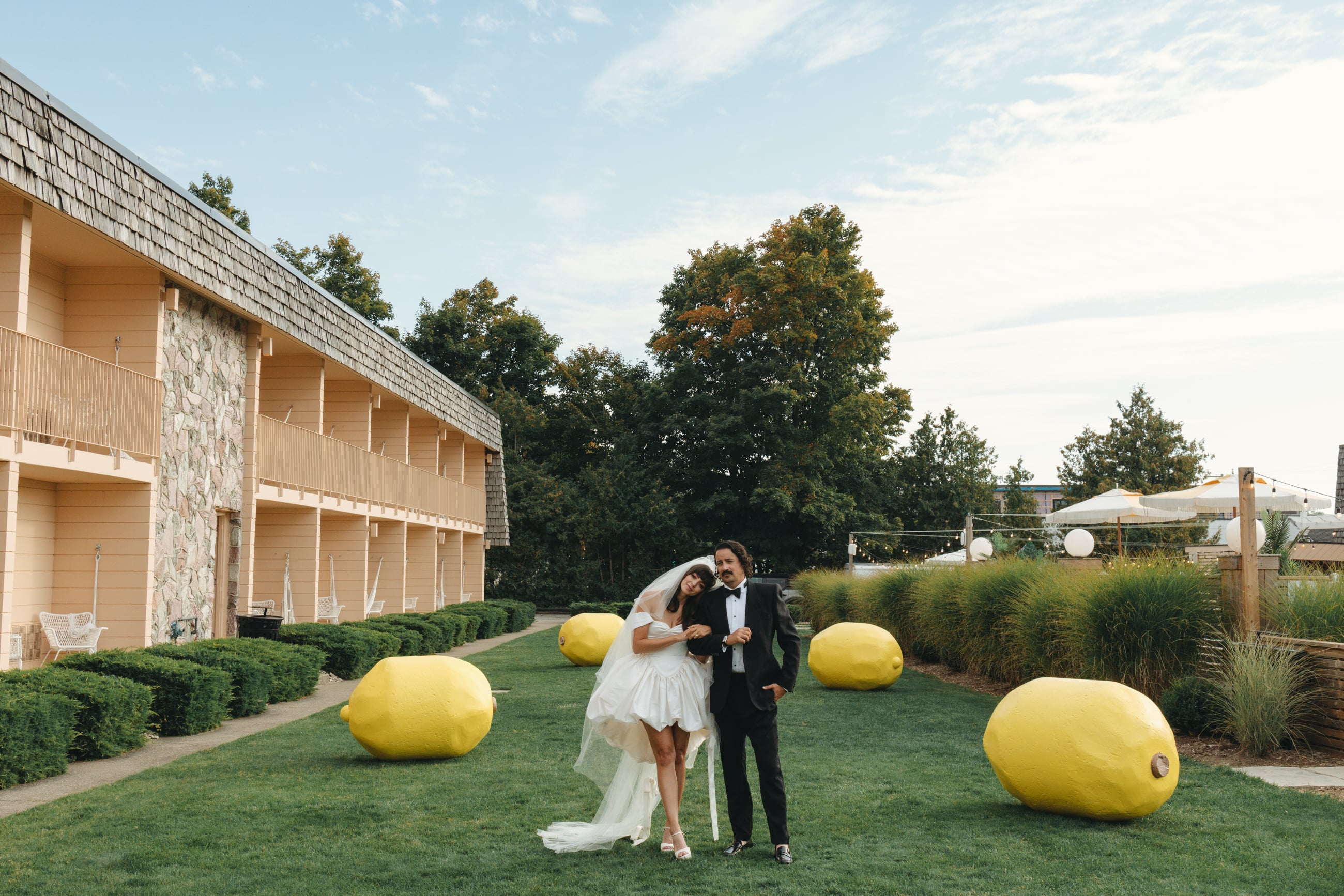 Bride and groom in front of lemon sculptures