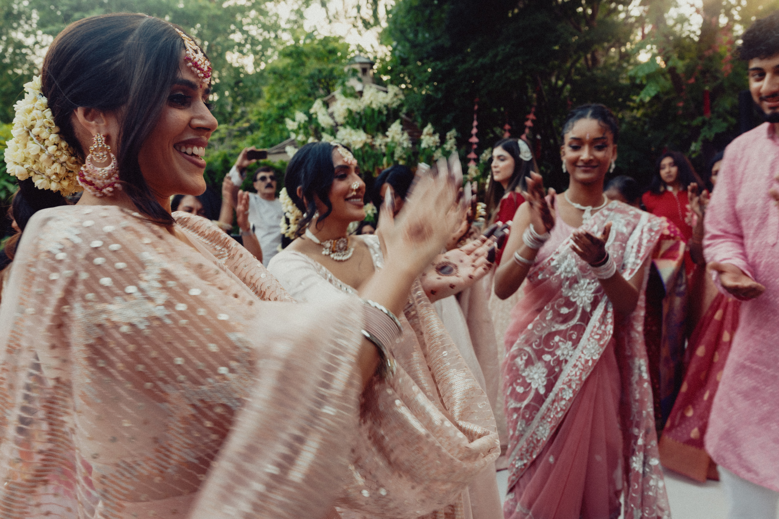 Wedding guests clap and cheer during the mehndi celebration.