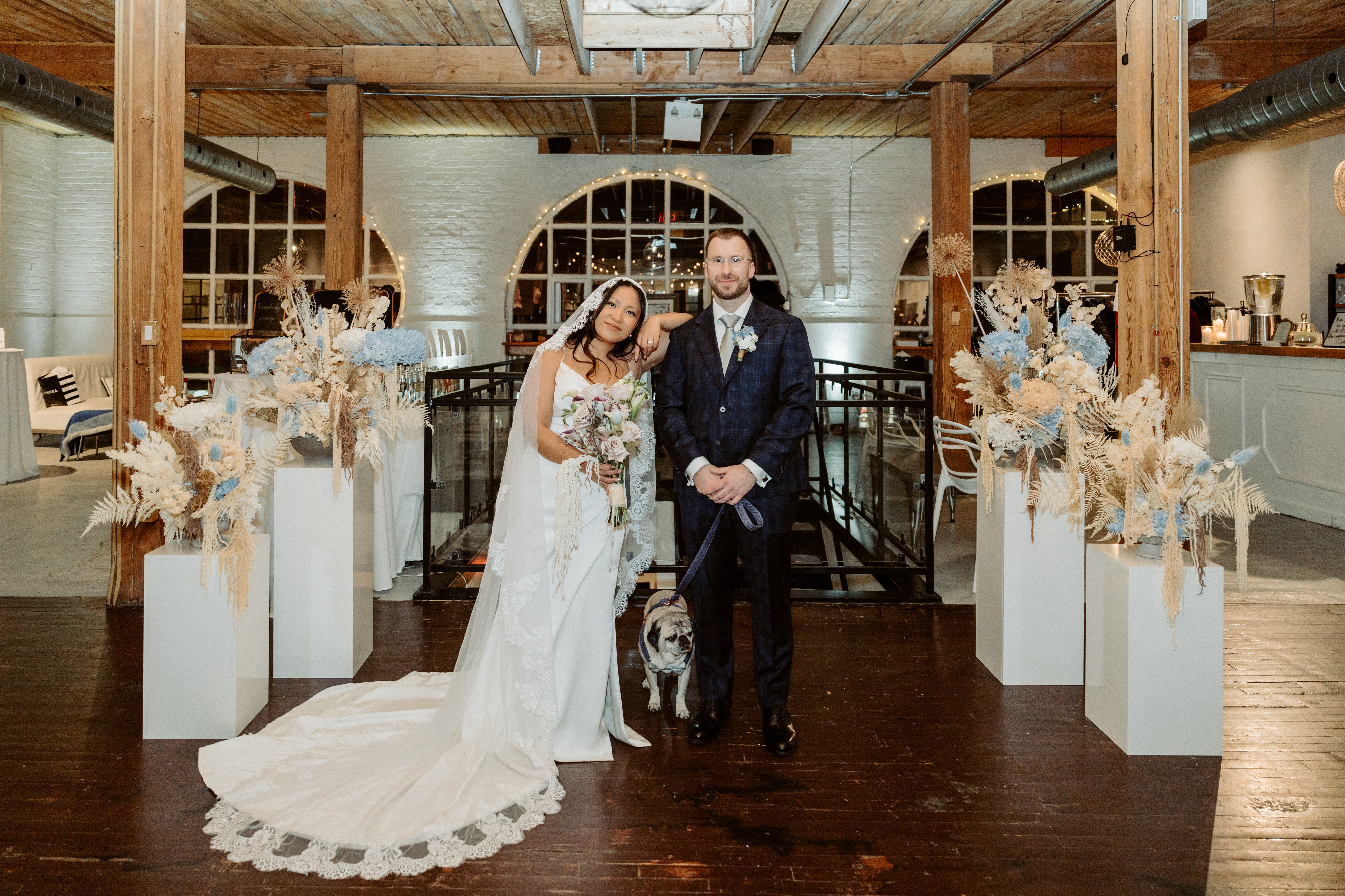 Bride and groom and dog inside empty venue