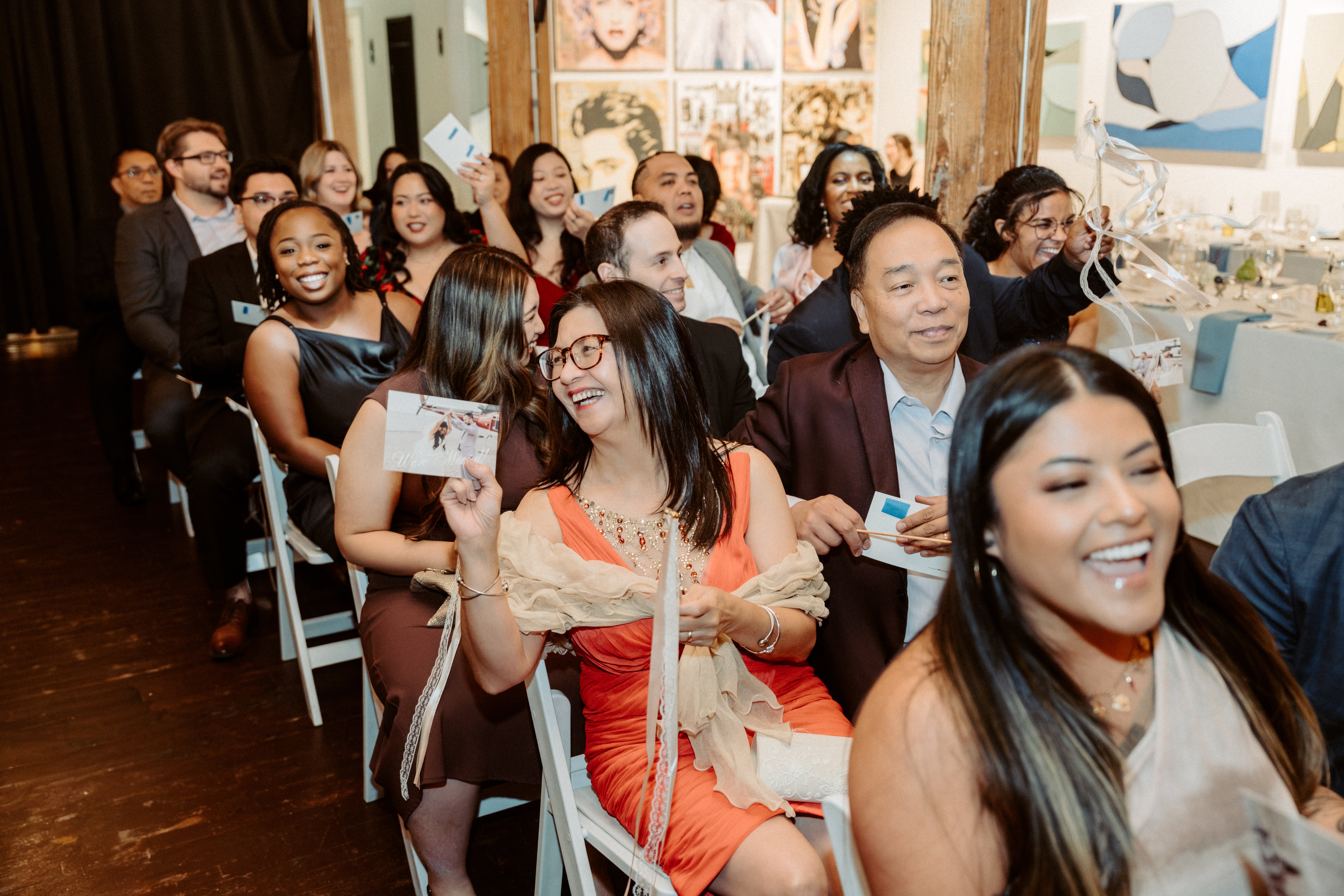 People finding postcards under chairs
