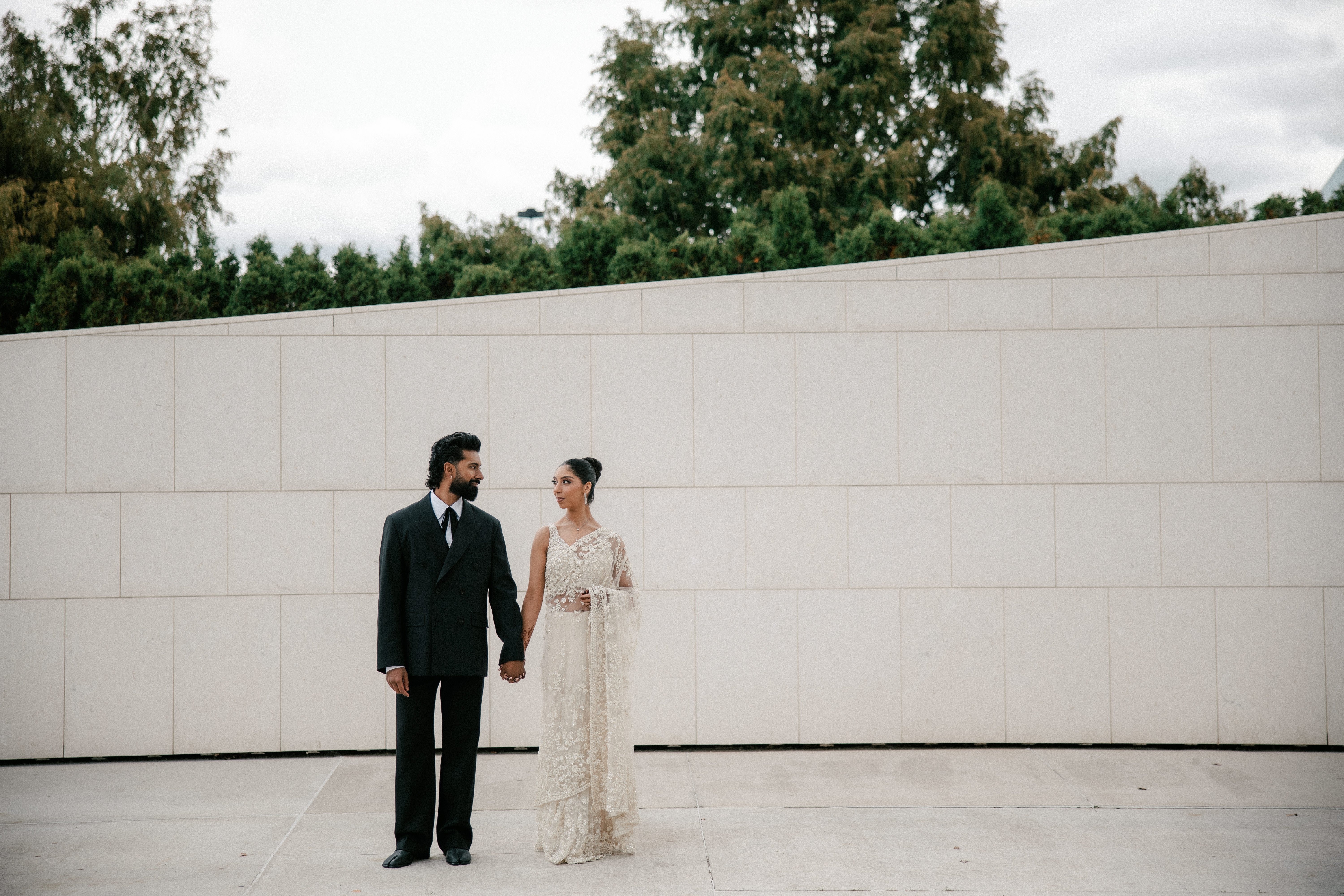 Elegant bride and groom holding hands