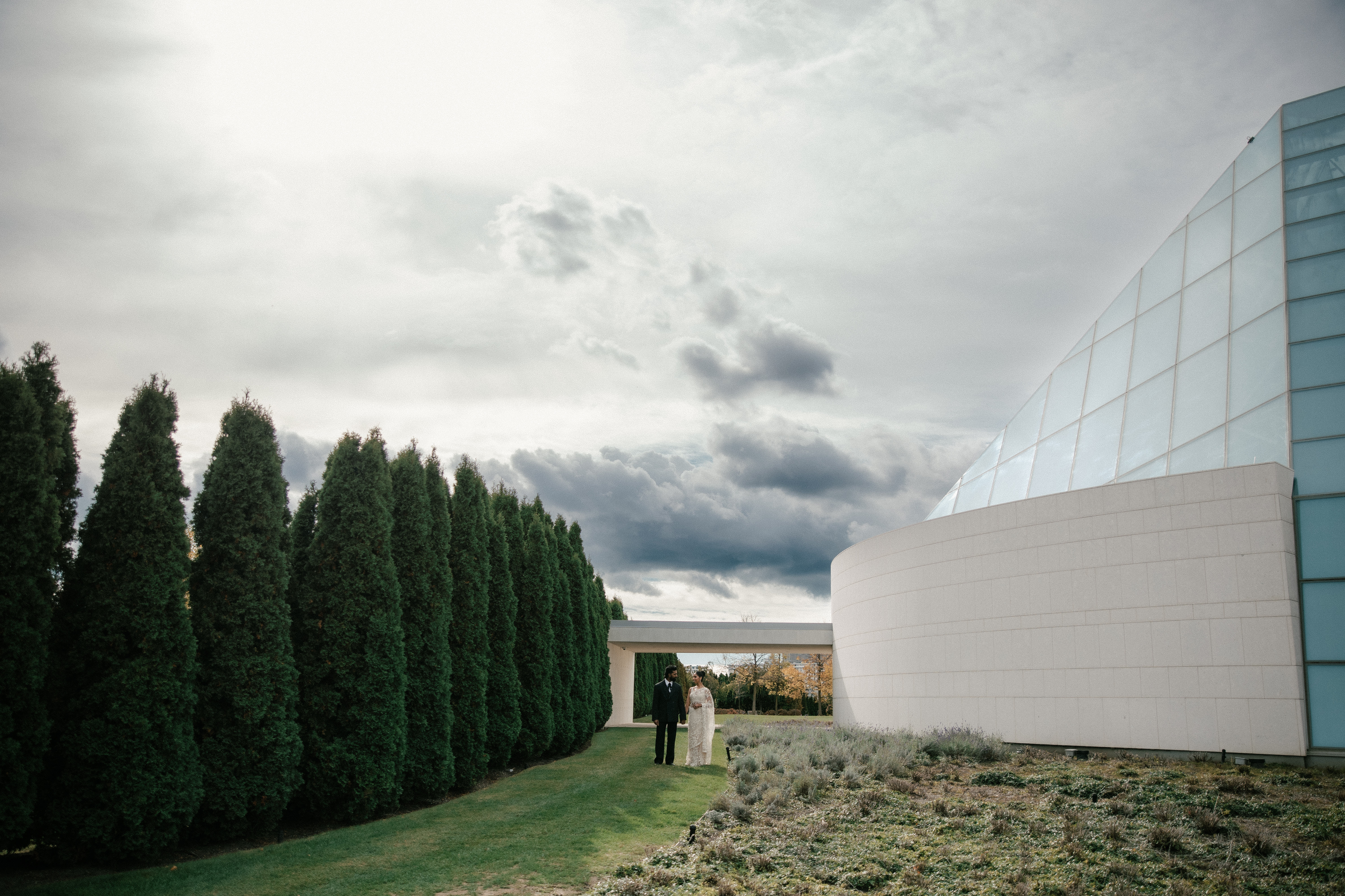 Couple standing outside in front of Ismaili Centre, Toronto