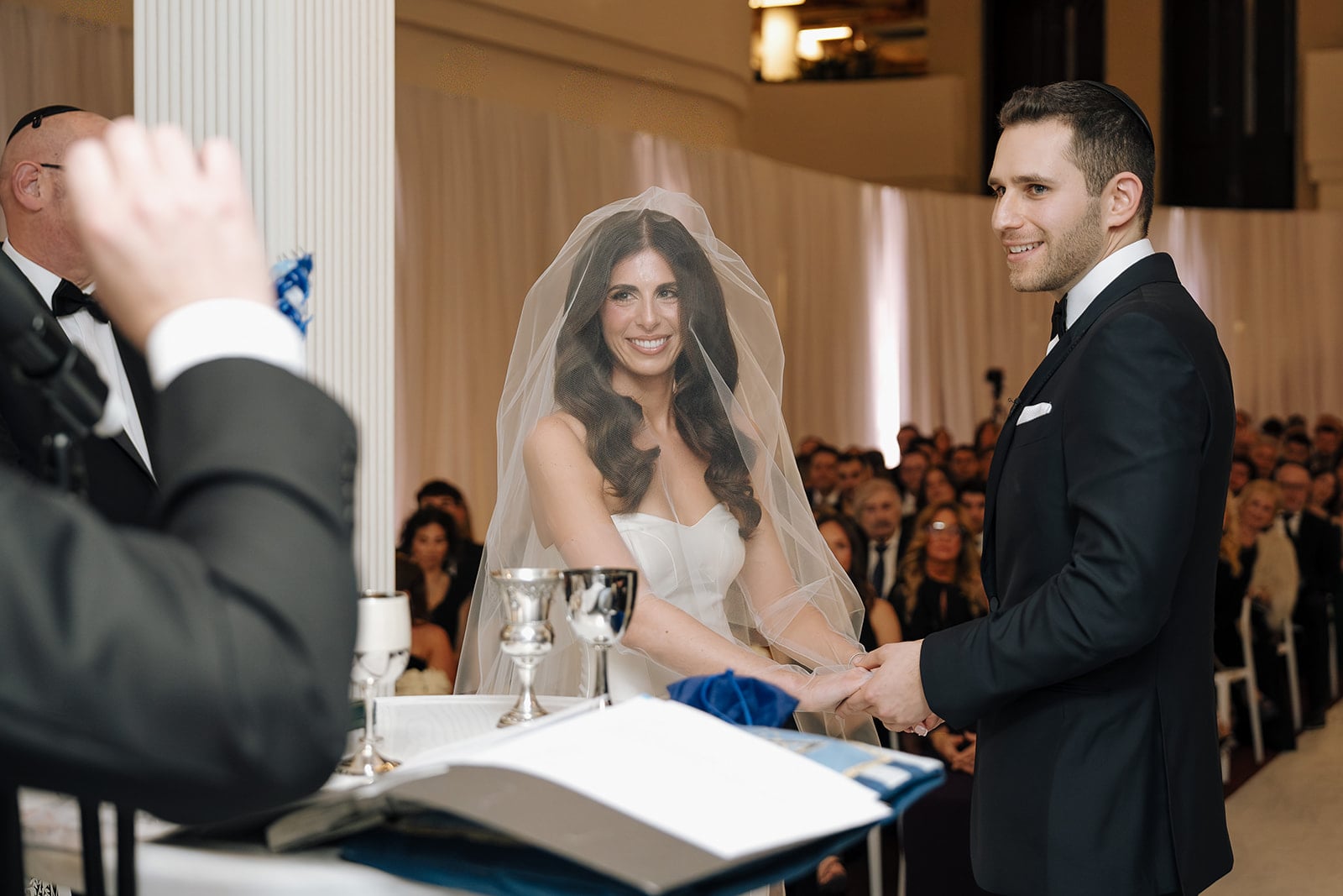 Bride and groom holding hands during ceremony