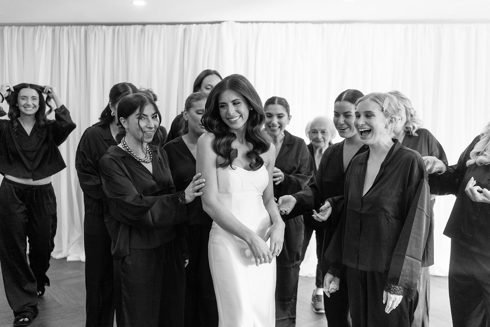 Bride surrounded by bridesmaids