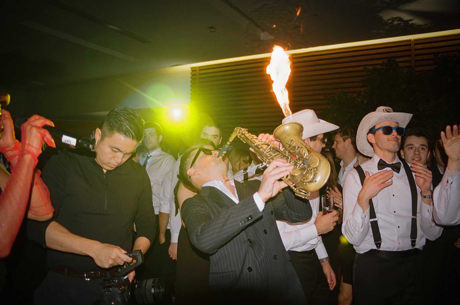 Musician blowing fire out of a saxophone
