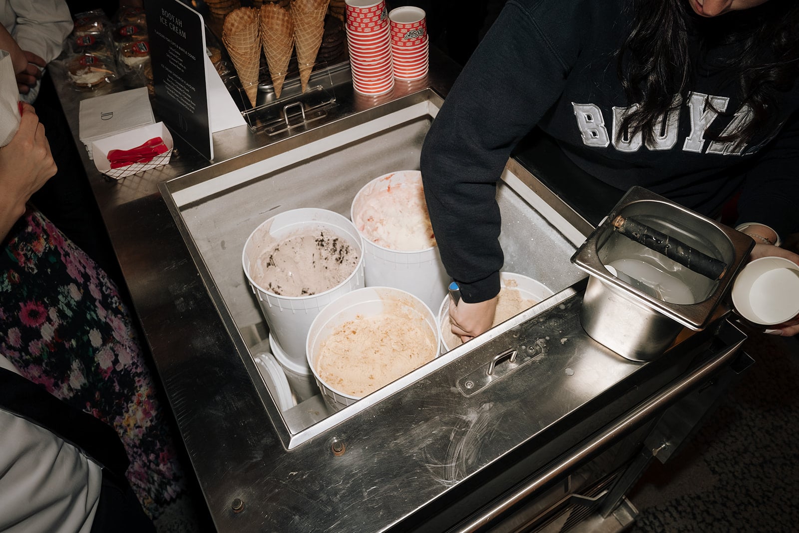 Person scooping ice cream from a bucket