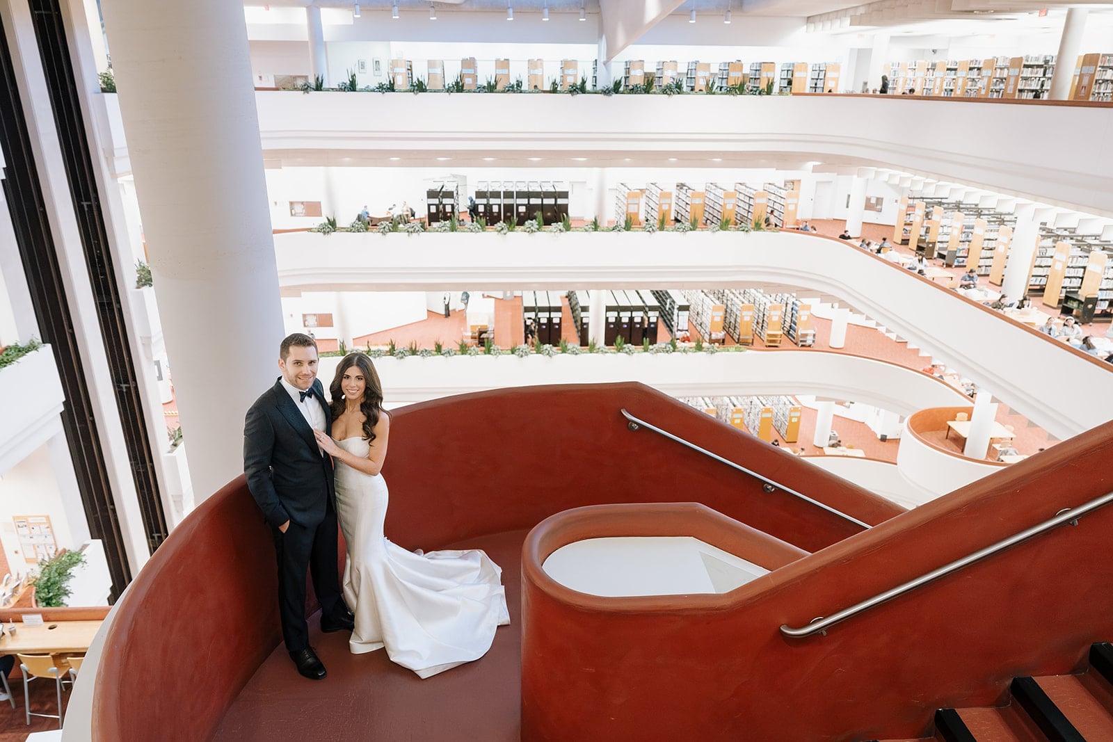 Aerial view of bride and groom on a curved staircase