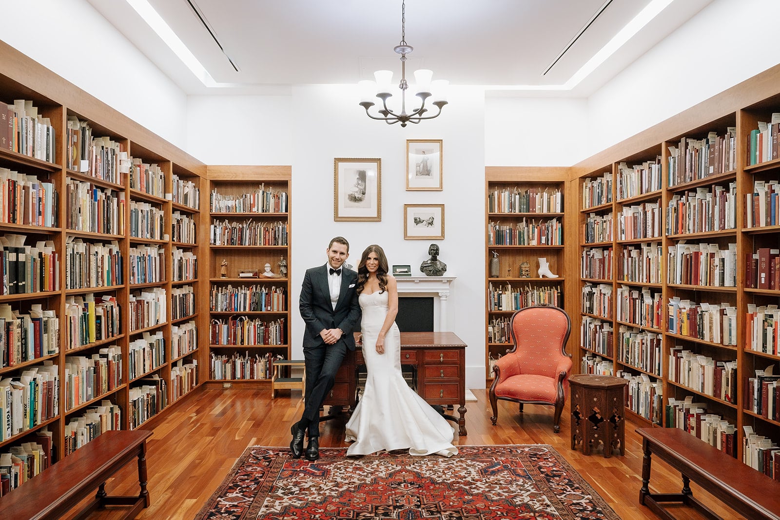 Bride and groom in a small room filled with books