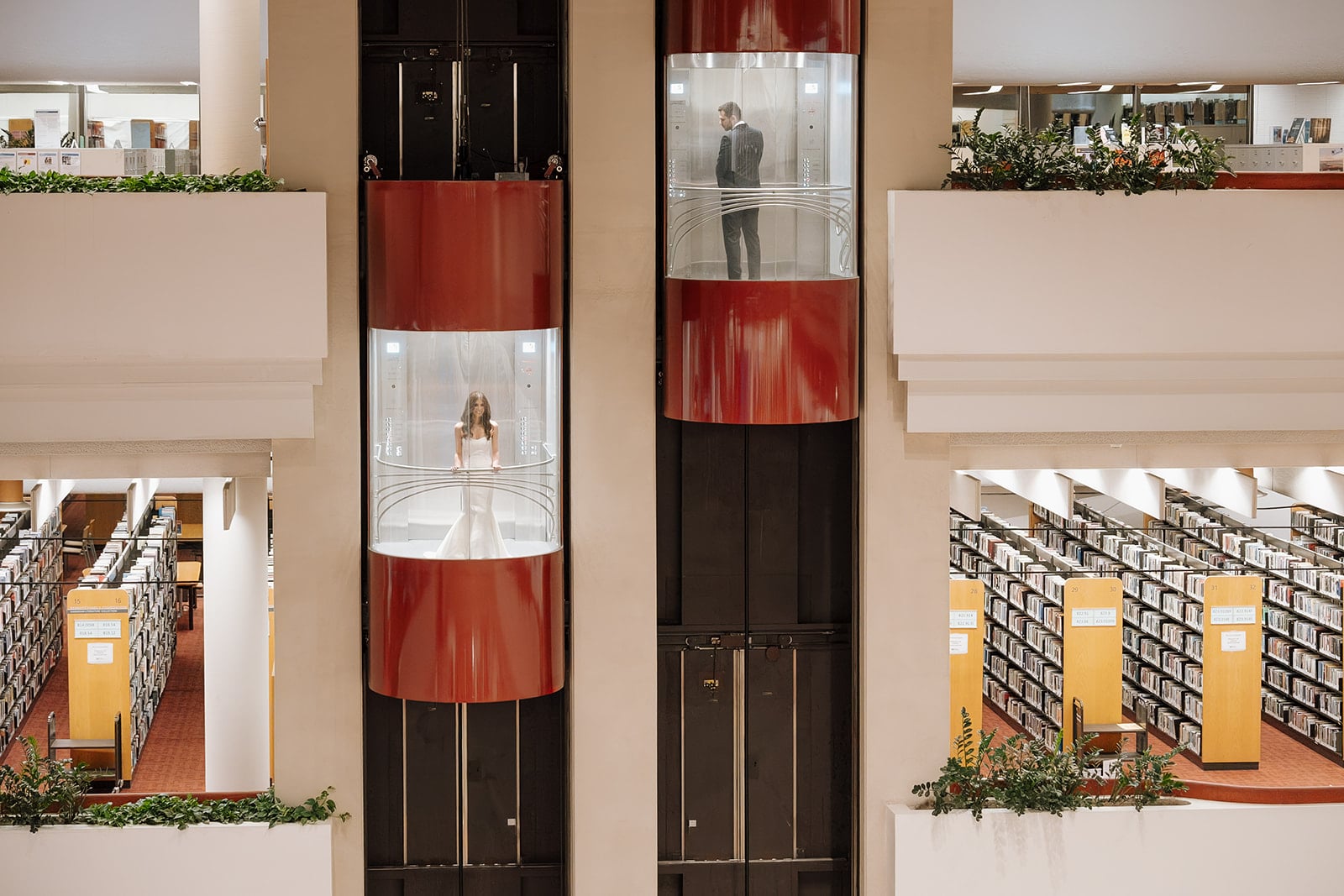 Bride and groom in Toronto Reference Library glass elevators